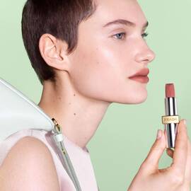 Model wearing Prada Monochrome Hyper Matte Lipstick in shade P60