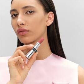 Model wearing Prada Monochrome Soft Matte Lipstick in shade B101, showcasing the rich color payoff.