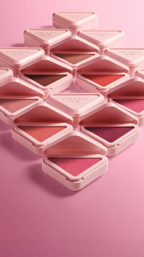 Prada Touch Range Packs Open forming a diamond on a pink gradient background