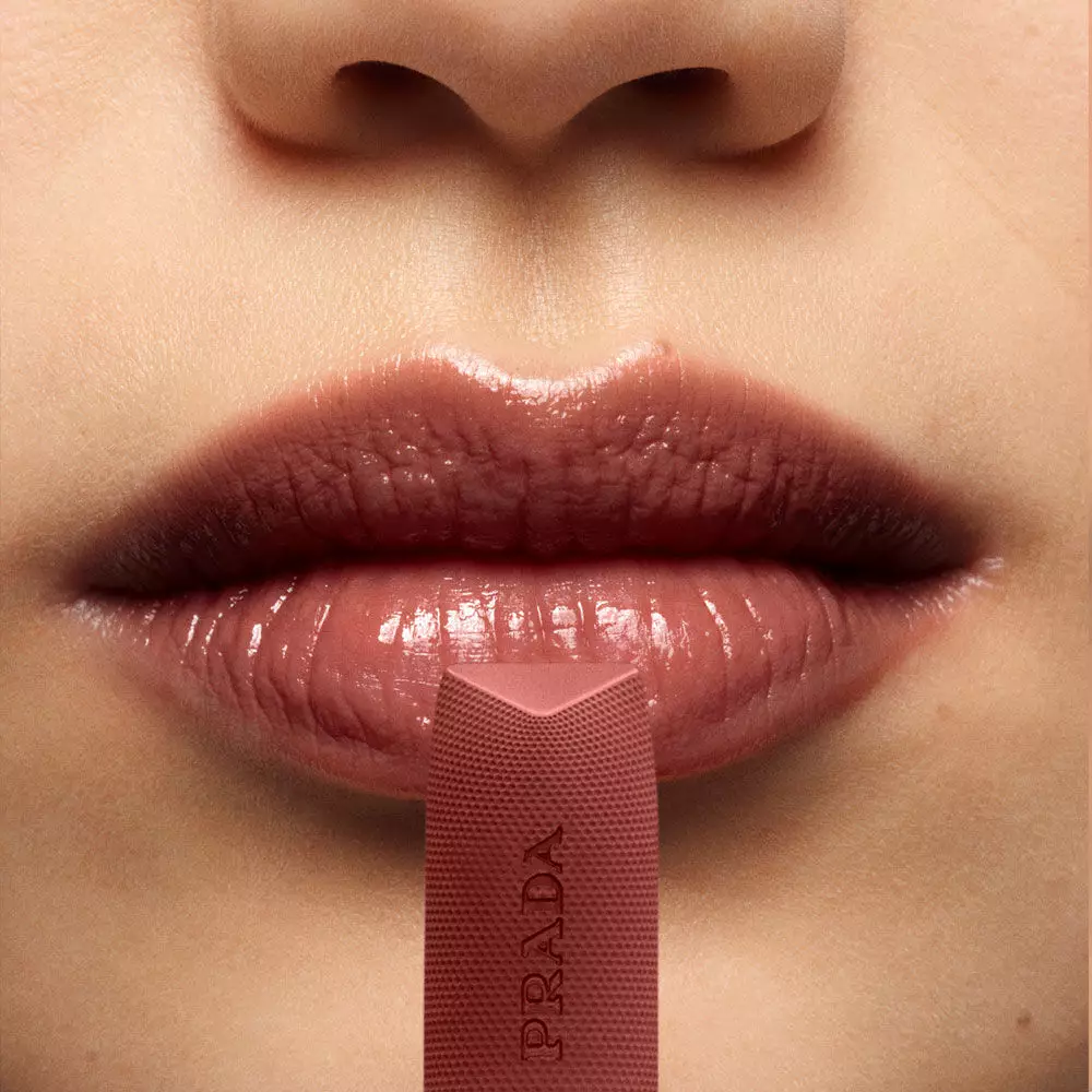 Close-up of lips wearing Prada Balm Lip Optimizing Care in shade U010.