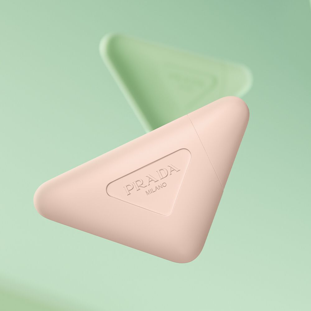 Prada Paradoxe Hand Cream and Prada Hand Cream floating on a green background