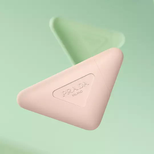 Prada Paradoxe Hand Cream and Prada Hand Cream floating on a green background