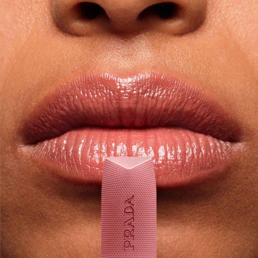 Close-up of lips wearing Prada Balm Lip Optimizing Care in shade U011.
