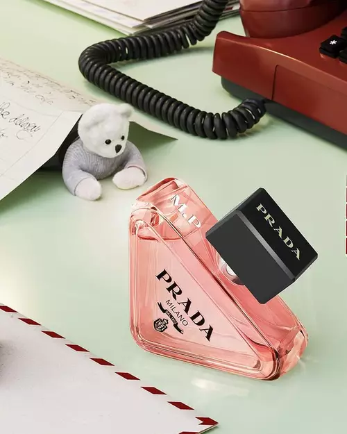 Prada Beauty Digital Services Engraving - Holiday Paradoxe Eau de Parfum engraved with red phone, teddy bear, and letters on a light green background