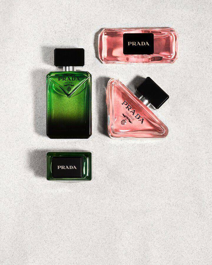 Prada Paradoxe Eau De Parfum and Paradigme Eau De Parfum facing view and above view on white sand