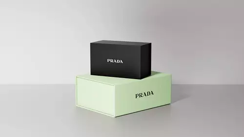 Prada Beauty Digital Services Gifting - Two Gift Boxes with Paradigme and Paradoxe on top on a Neutral Gray Background