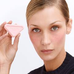 Bella Hadid holding Prada Touch blush and wearing shade Dahlia and Caffe.
