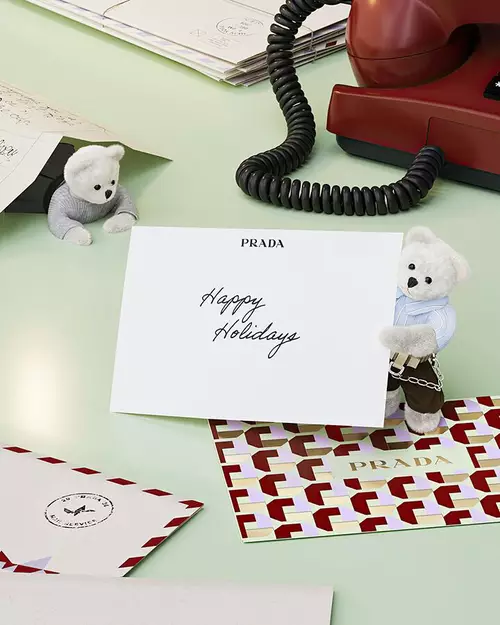 Prada Beauty Digital Services E-Gift Card - Holiday card with teddy bears, letters, and red phone on a light green background