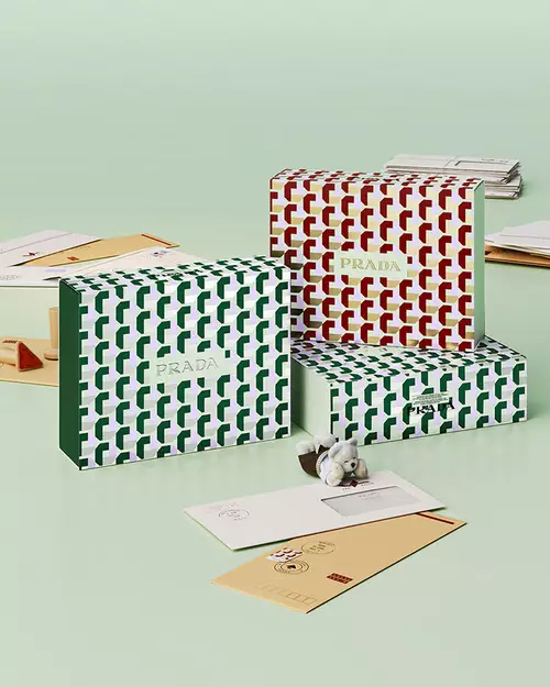 Prada Beauty Digital Services Shipping - Three Holiday Gift Boxes with letters and teddy bear on a light green background
