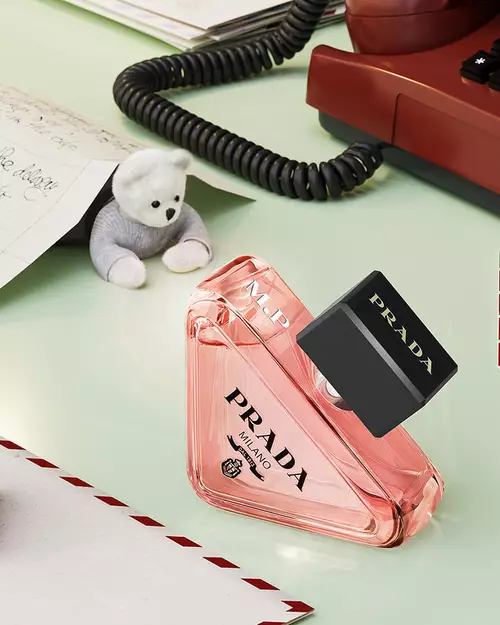 Prada Beauty Digital Services Engraving - Holiday Paradoxe Eau de Parfum engraved with red phone, teddy bear, and letters on a light green background