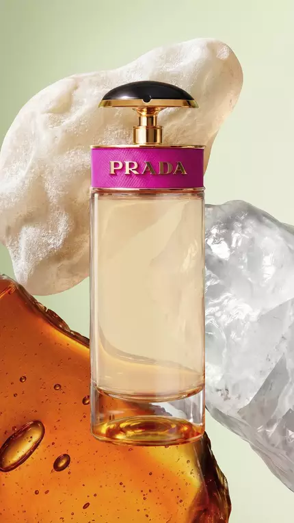 Prada Candy EDP Pack with ingredients on a green background