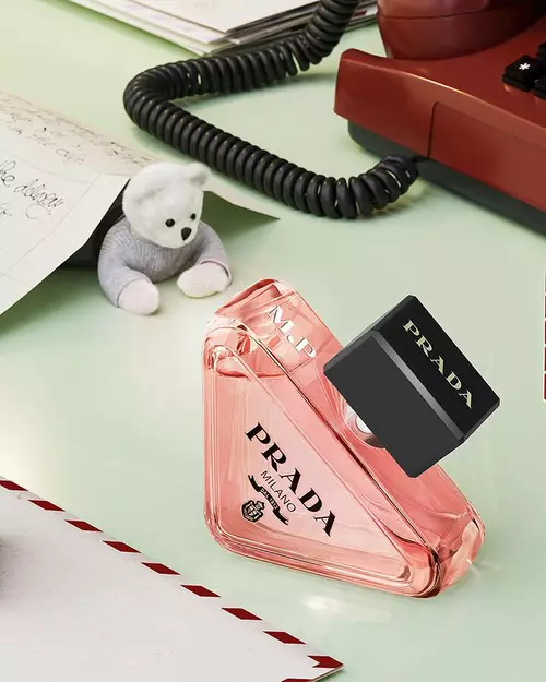 Prada Beauty Digital Services Engraving - Holiday Paradoxe Eau de Parfum engraved with red phone, teddy bear, and letters on a light green background