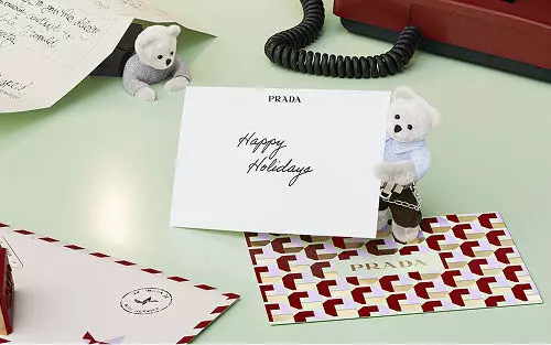 Prada Beauty Holiday card with teddy bears, letters, and red phone on a light green background