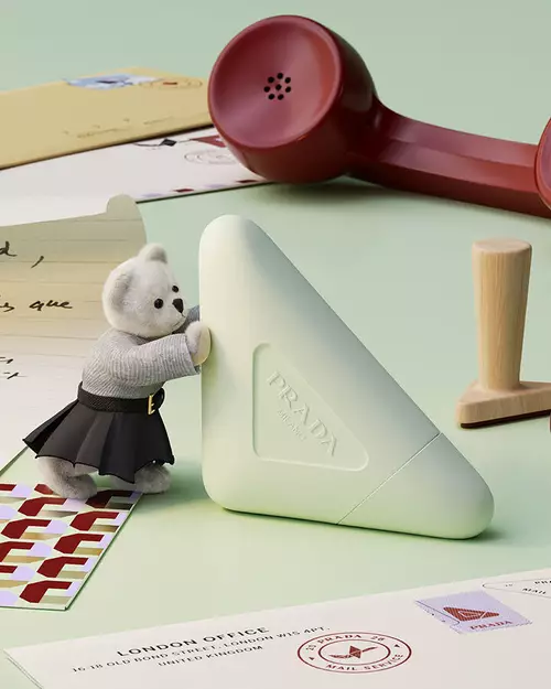 Prada Hand Cream in a holiday environment with letters, teddy bear and light green background