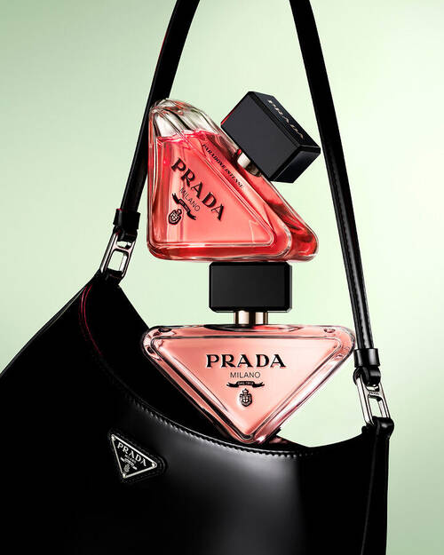 Prada Paradoxe Eau De Parfum and Eau De Parfum Intense Pradaness Lifestyle with black Prada bag and light green background