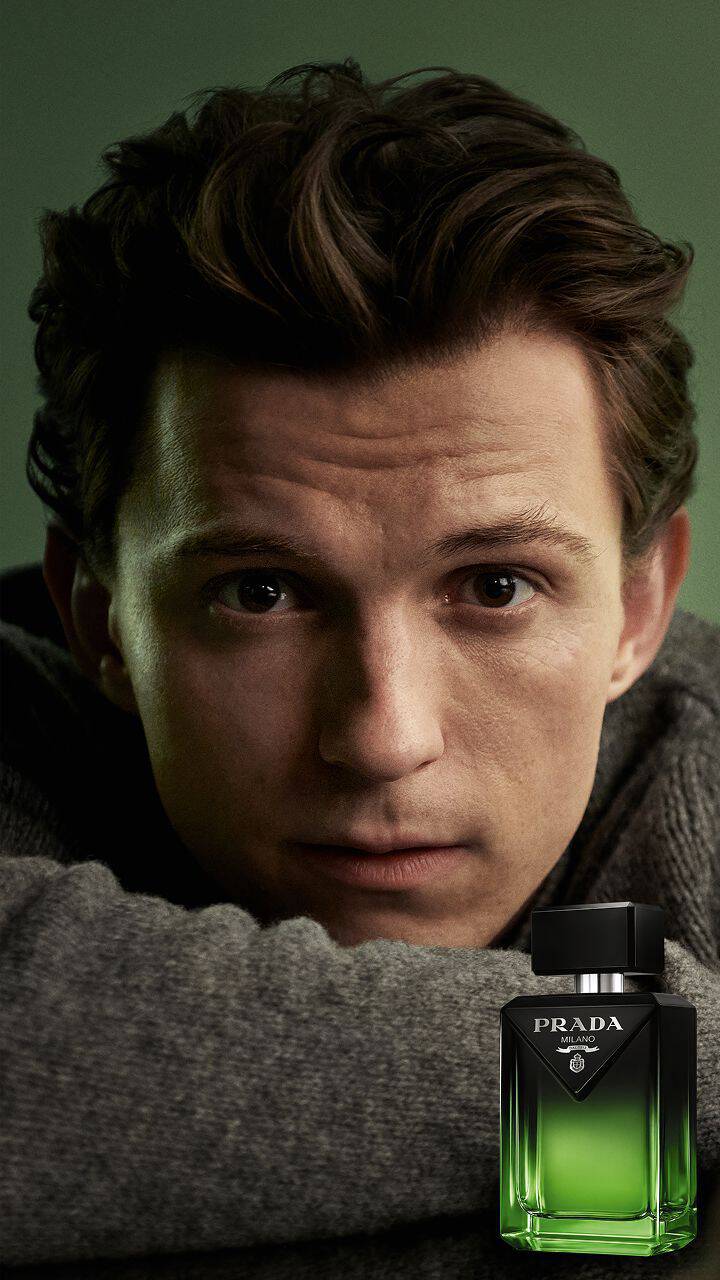 Prada Paradigme Le Parfum Ambassador Tom Holland with Pack on Green Background