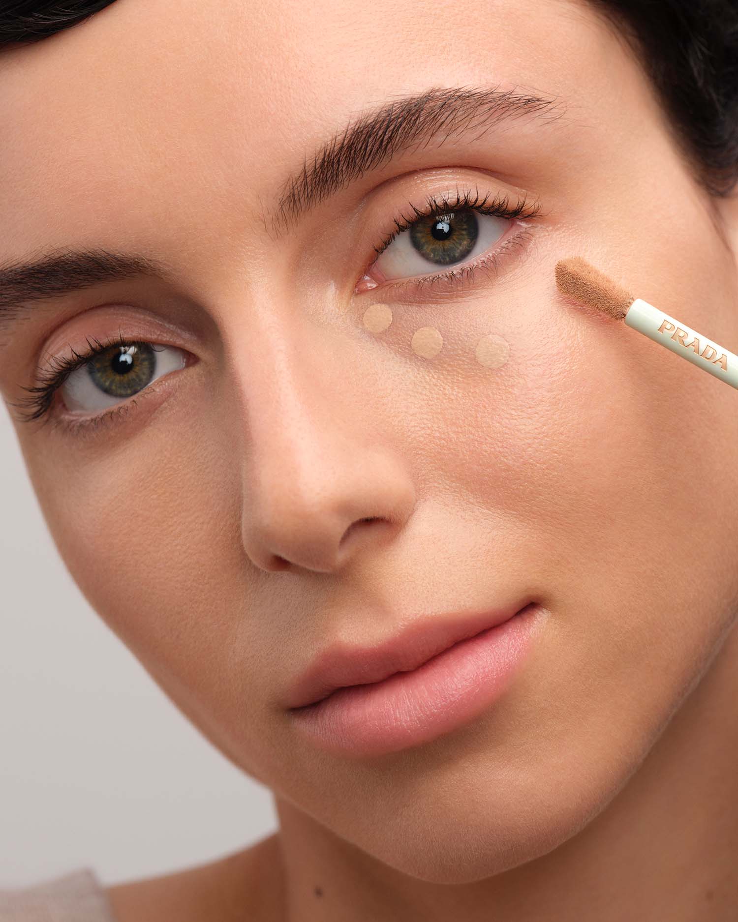 Model applying Prada Conceal.