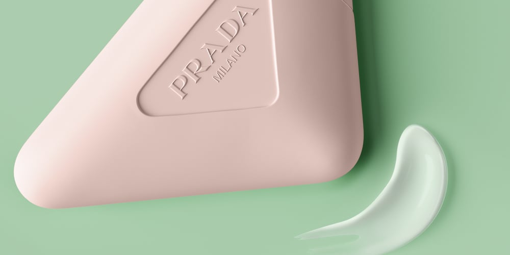 Prada Paradoxe Hand Cream with Texture Swatch on a Green Background