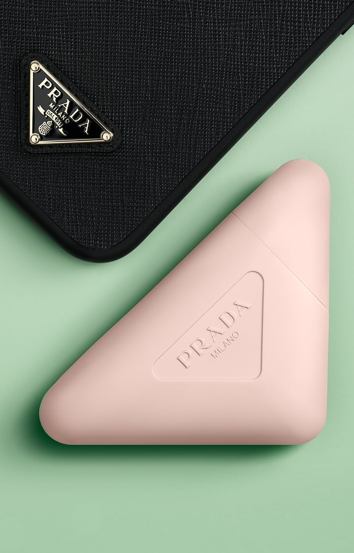 Prada Paradoxe Hand Cream with Prada Black Phone Case on a Green Background