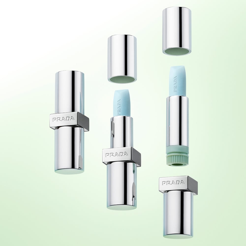 Prada Balm Lip Hydrating Care in shade Astral Pink Refillable Mechanism on a light green background 