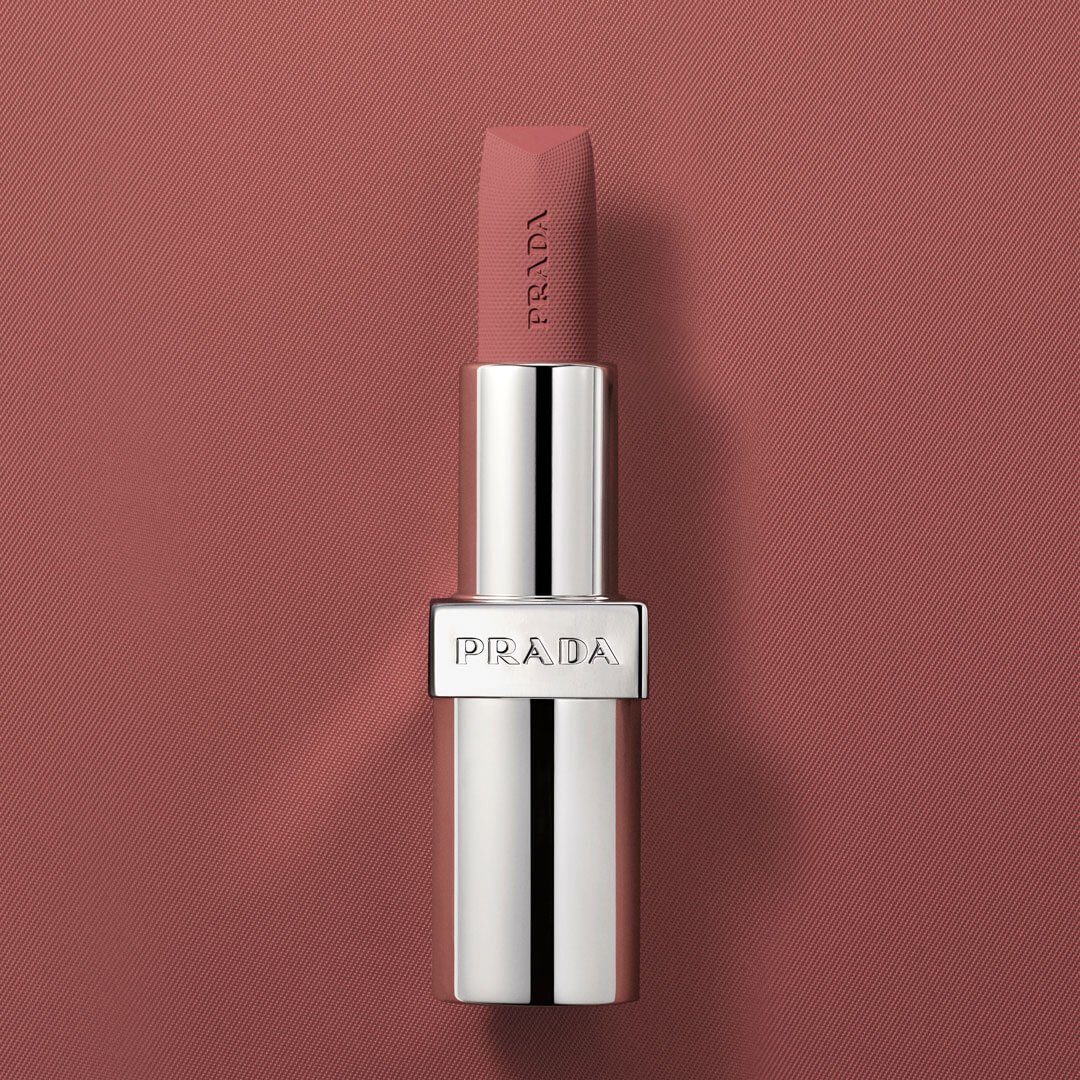 Model wearing Prada Monochrome Hyper Matte Lipstick showcasing the rich color payoff.